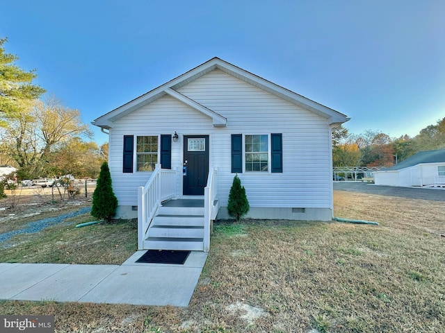 bungalow-style house with a front yard