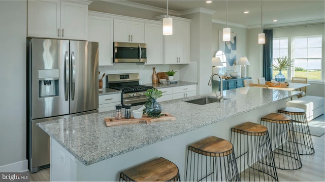 6819 Winterhill Ln, Glen Burnie, MD 21060 - kitchen featuring white cabinetry, appliances with stainless steel finishes, a kitchen bar, and a sink