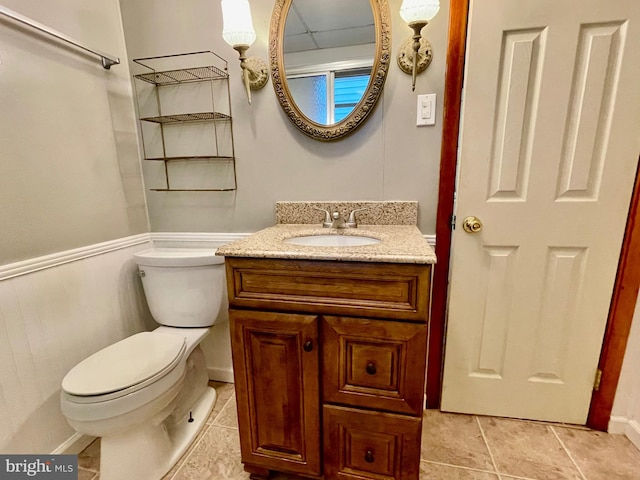 bathroom with vanity, toilet, and tile patterned floors