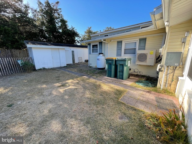 view of yard with ac unit and a storage shed