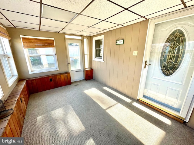 unfurnished sunroom with a drop ceiling