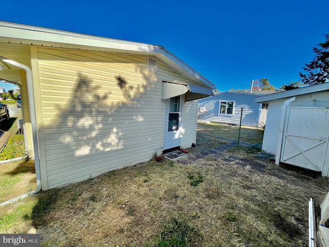 view of side of property featuring a storage unit