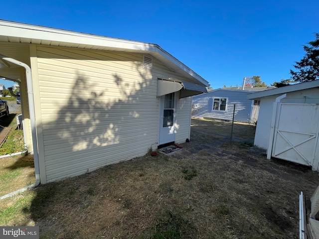 view of home's exterior featuring a storage unit