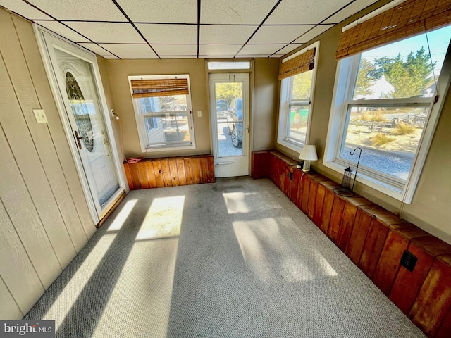 unfurnished sunroom with a drop ceiling