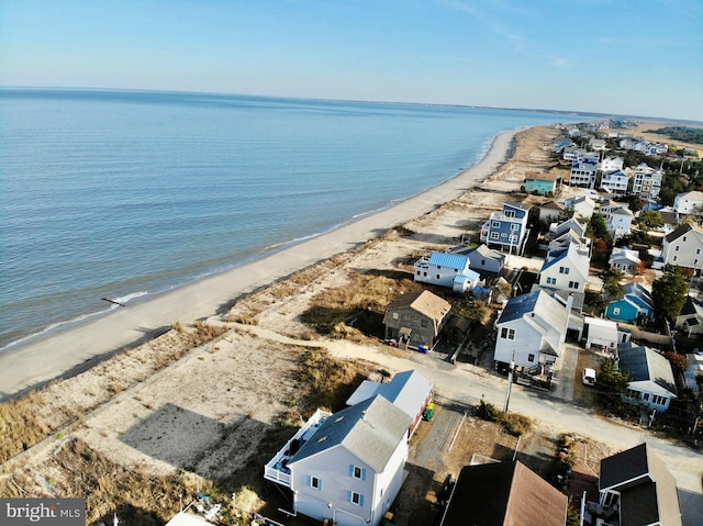 birds eye view of property featuring a water view and a beach view