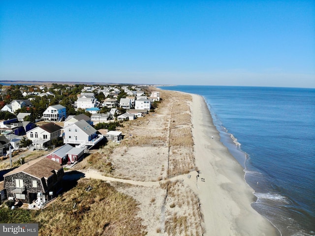 bird's eye view with a water view and a beach view