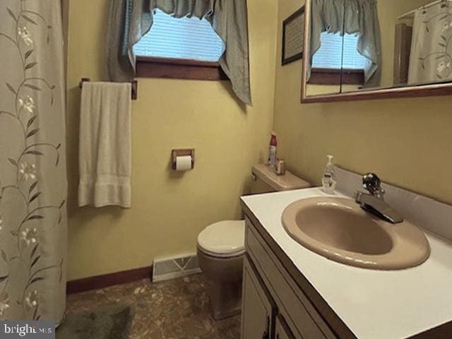 bathroom featuring toilet and vanity