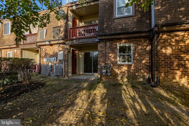 back of property featuring a balcony