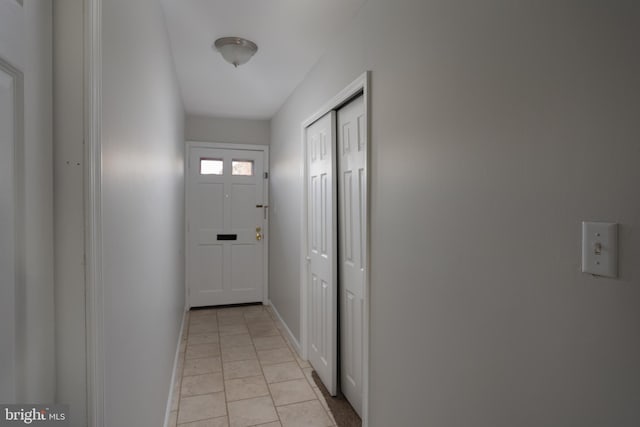 doorway to outside featuring light tile patterned flooring