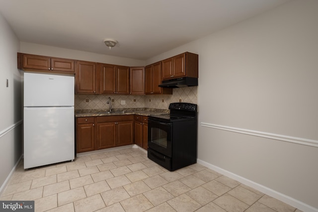 kitchen featuring white fridge, black range with electric cooktop, tasteful backsplash, and sink