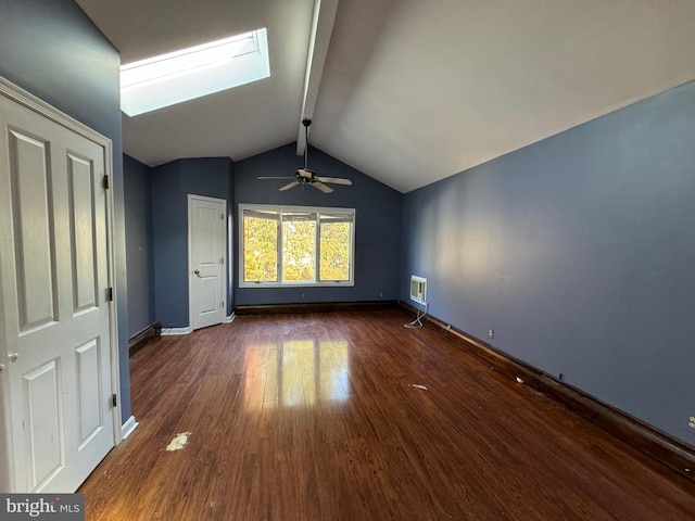 interior space featuring ceiling fan, dark hardwood / wood-style flooring, and lofted ceiling with skylight