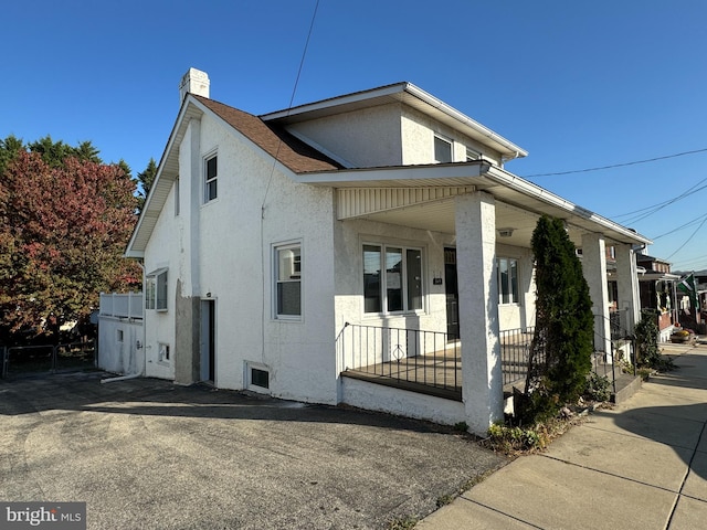 view of side of home with a porch