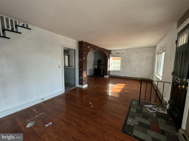 unfurnished living room with dark wood-type flooring