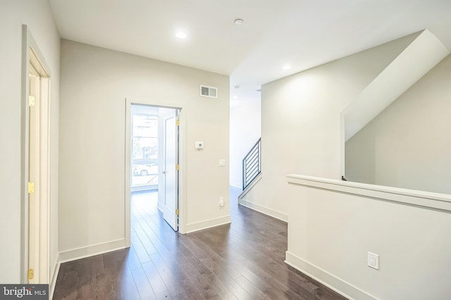 corridor featuring dark hardwood / wood-style flooring