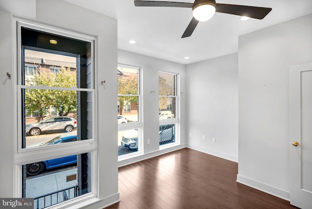 interior space with dark wood-type flooring and ceiling fan