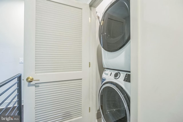 laundry room featuring stacked washer / drying machine