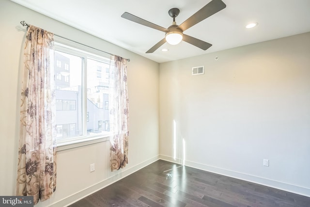 unfurnished room featuring ceiling fan and dark hardwood / wood-style floors