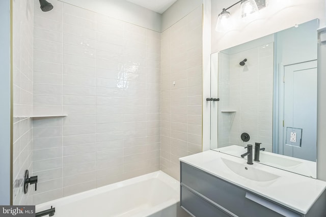 bathroom with vanity and tiled shower / bath combo