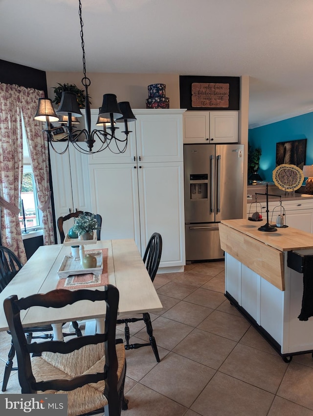 tiled dining space with a notable chandelier