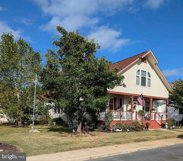 view of front of property with covered porch and a front lawn