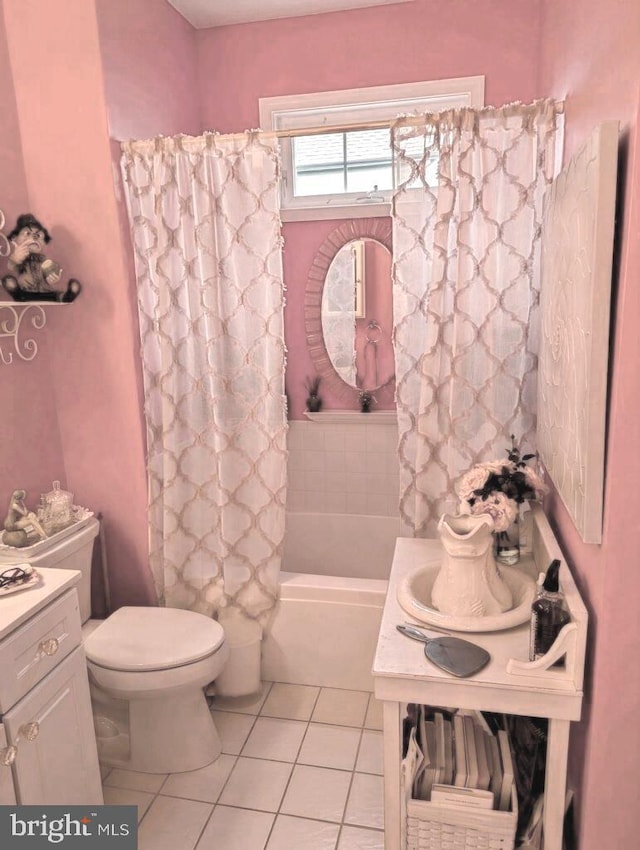 full bathroom featuring toilet, tile patterned flooring, vanity, and shower / bathtub combination with curtain