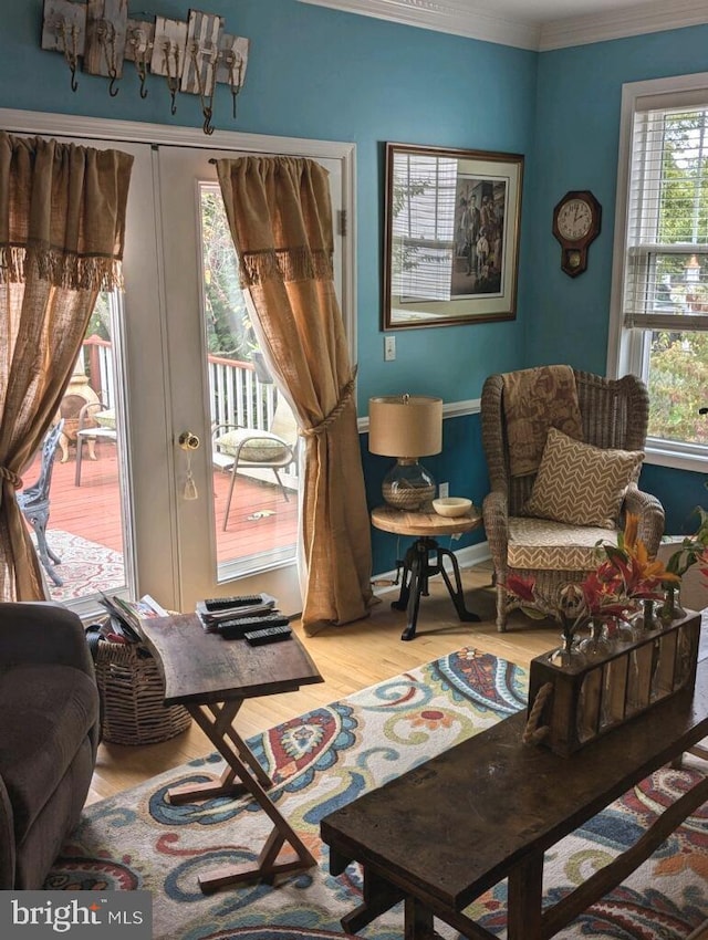 sitting room with crown molding and wood finished floors