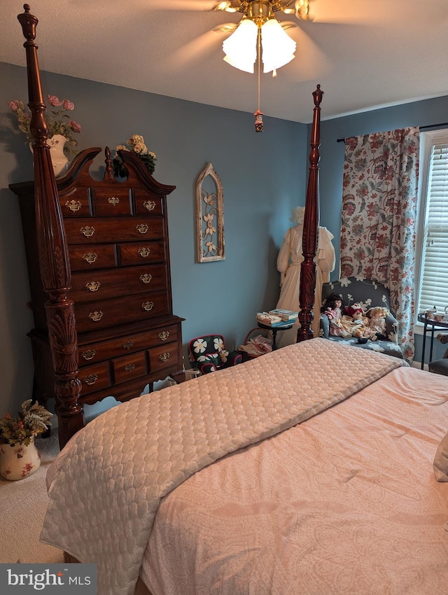 carpeted bedroom featuring a textured ceiling and ceiling fan