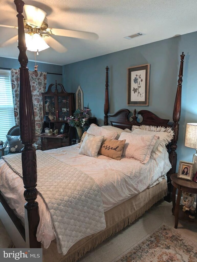 bedroom with ceiling fan and visible vents