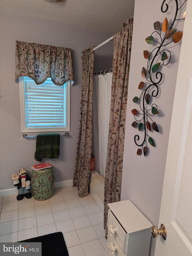 bathroom with tile patterned floors and a textured ceiling