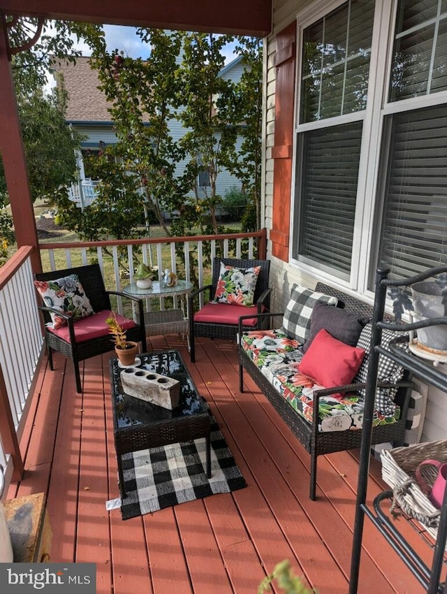 wooden terrace with an outdoor hangout area