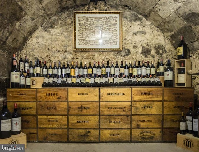 wine area featuring concrete floors