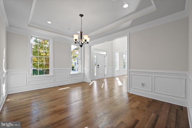 interior space featuring a chandelier, crown molding, dark hardwood / wood-style floors, and plenty of natural light