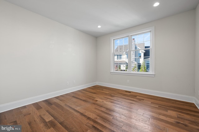 spare room featuring dark wood-type flooring