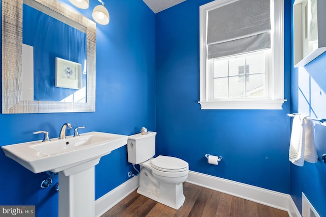 bathroom with wood-type flooring, sink, and toilet