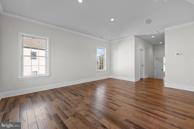 empty room featuring a healthy amount of sunlight, dark hardwood / wood-style flooring, and crown molding