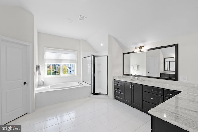 bathroom with tile patterned flooring, vanity, lofted ceiling, and independent shower and bath