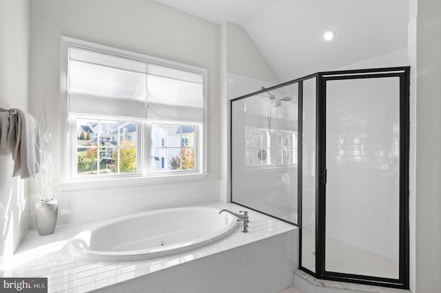 bathroom featuring independent shower and bath and vaulted ceiling