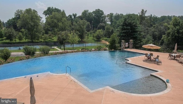 view of swimming pool featuring a patio area