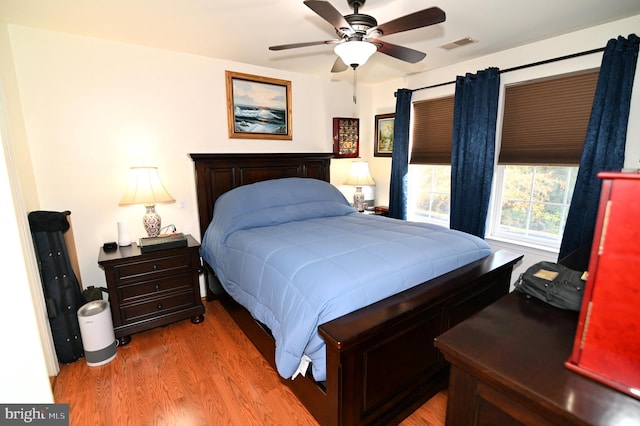 bedroom with light hardwood / wood-style floors and ceiling fan