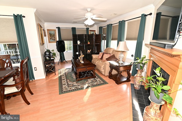 living room with ceiling fan, ornamental molding, and hardwood / wood-style floors