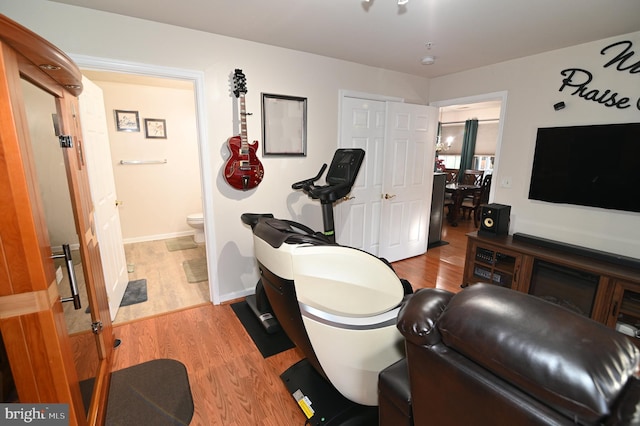 exercise room with light hardwood / wood-style flooring