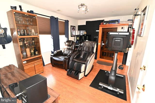 workout room featuring light hardwood / wood-style floors