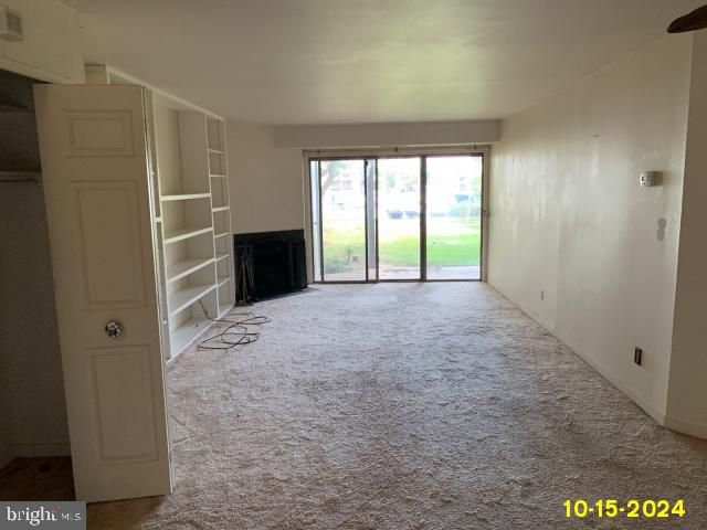 unfurnished living room featuring carpet