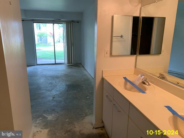 bathroom with vanity and concrete floors