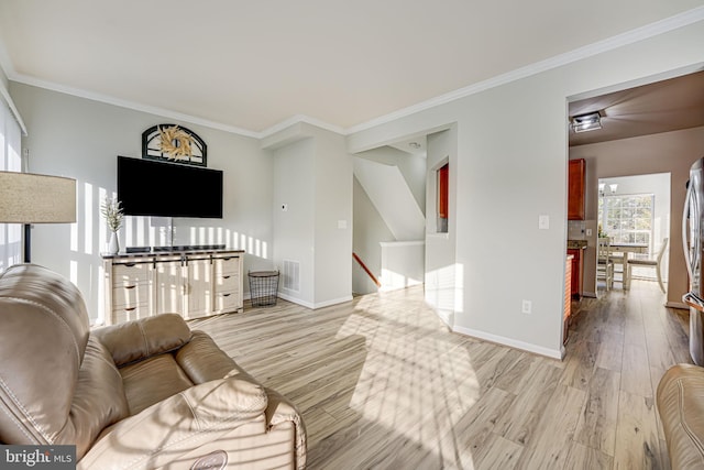 living room featuring ornamental molding and light wood-type flooring