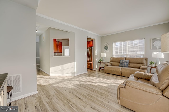 living room featuring ornamental molding and light hardwood / wood-style flooring