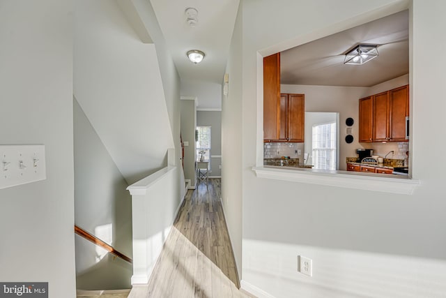 kitchen featuring light hardwood / wood-style floors and backsplash