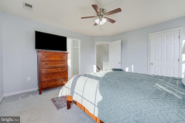 bedroom featuring light colored carpet and ceiling fan