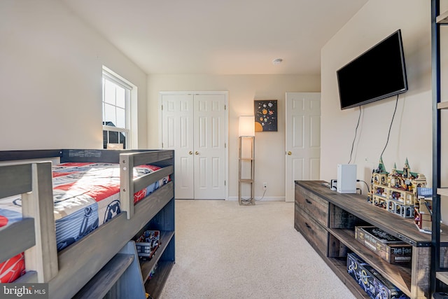 bedroom featuring light carpet and a closet