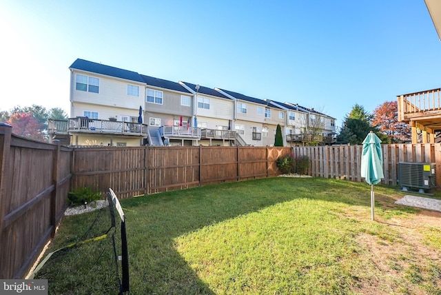 view of yard with a wooden deck and central AC